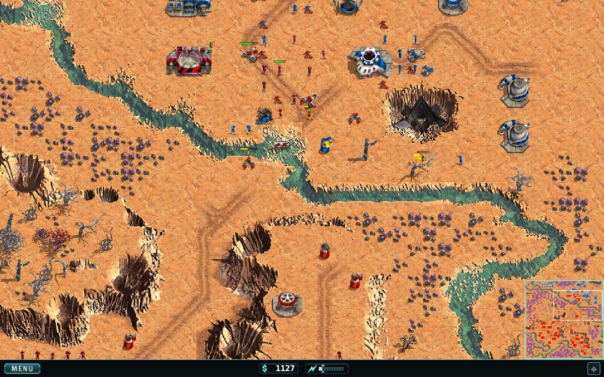Warfare Incorporated running in a browser: blue and red forces fighting across an orange desert map, with the HUD and minimap.